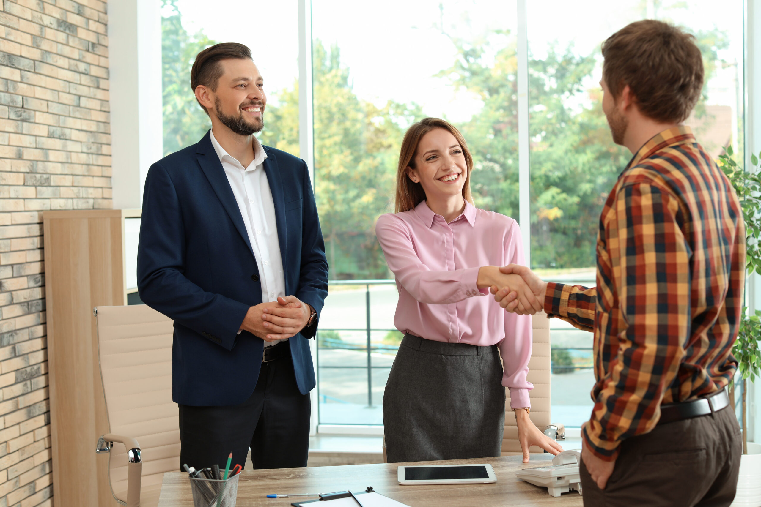 Two professionals shake hands after a successful pitch, capturing the confidence of direct sales.