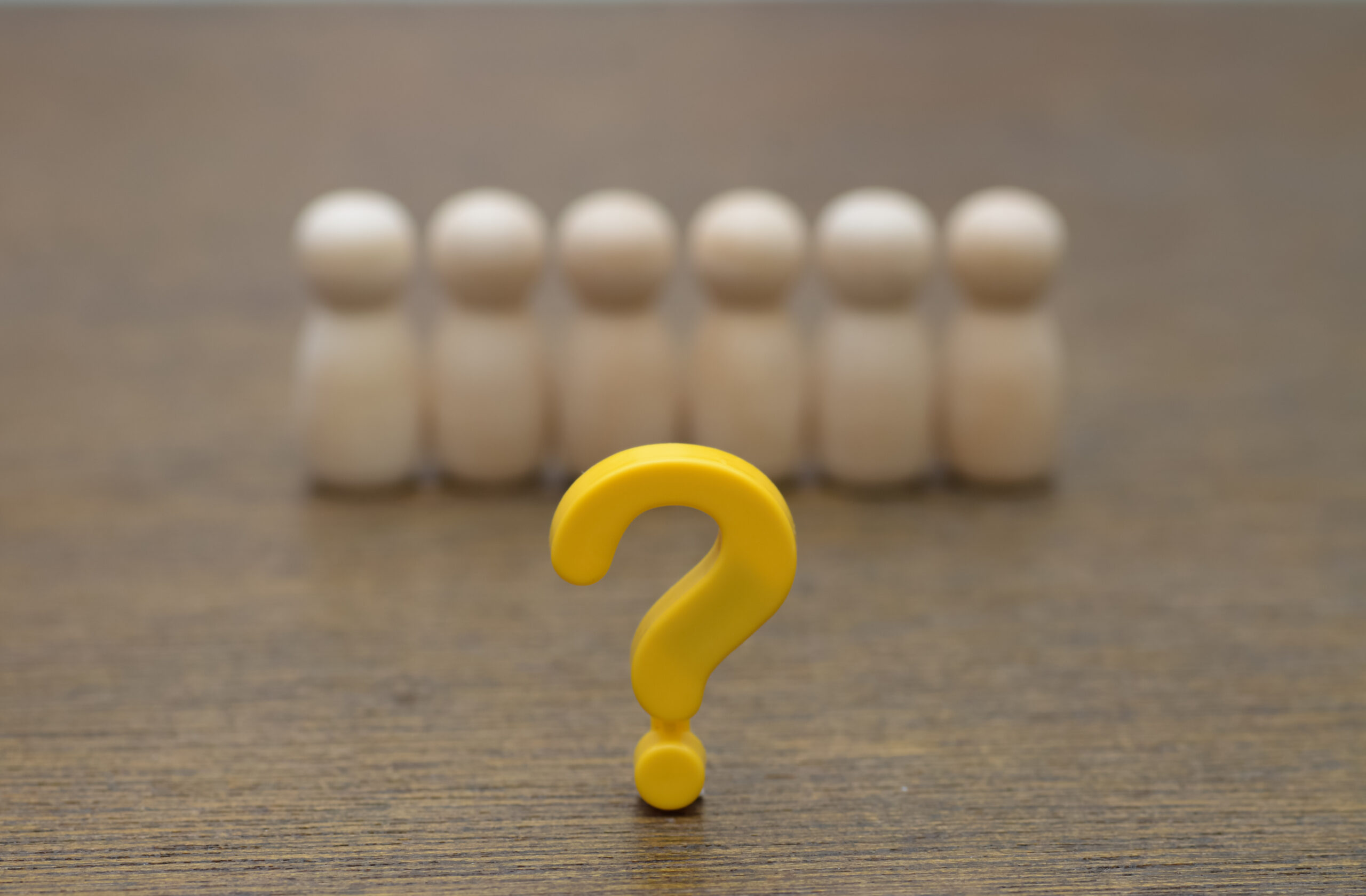 A yellow question mark before a group, representing curiosity around Signature Moorestown Group Reddit posts.