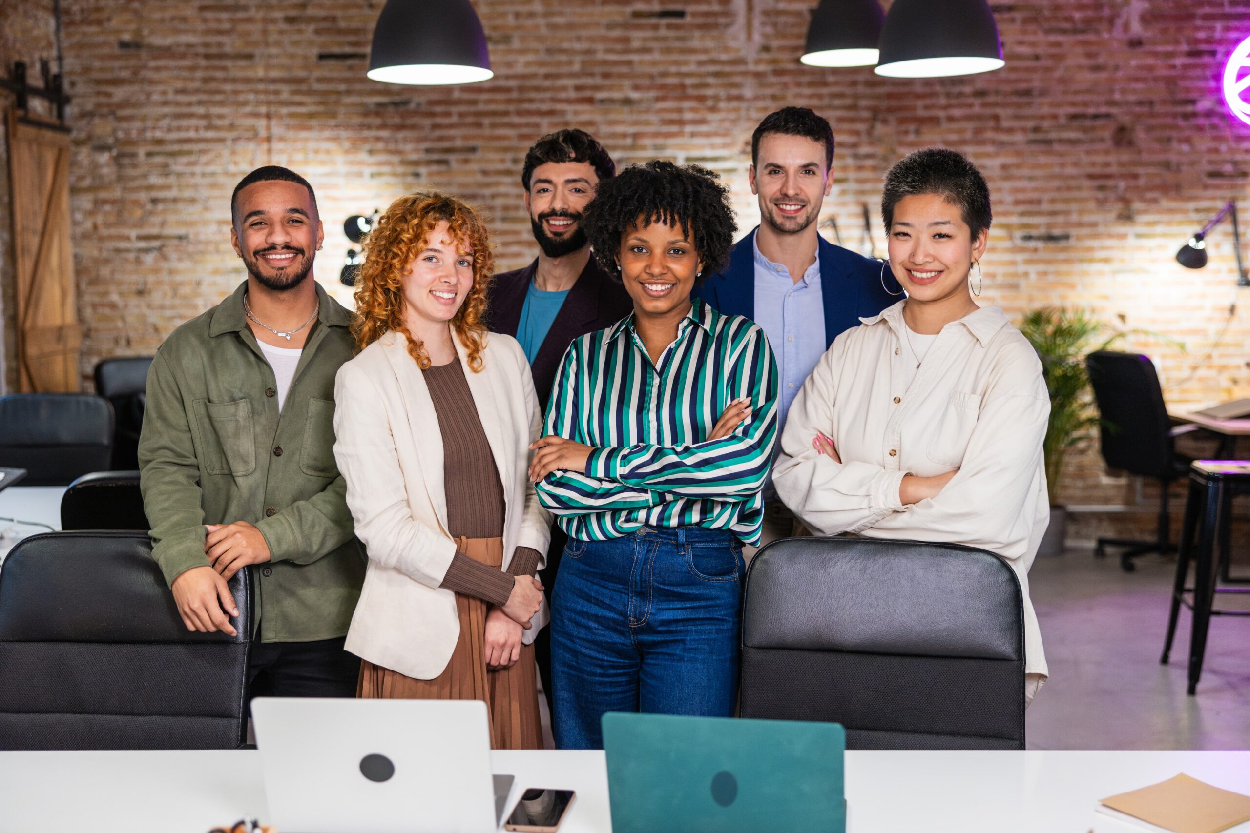 Signature Moorestown Group team members stand together in a welcoming office environment.